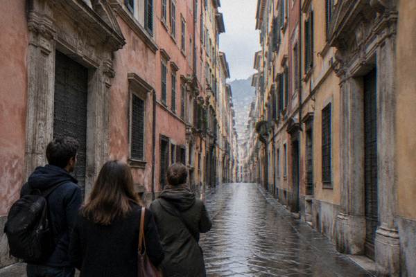 A private guide and a couple seen from behind pausing on a straight narrow street of tall rose and ochre palaces, Via Garibaldi