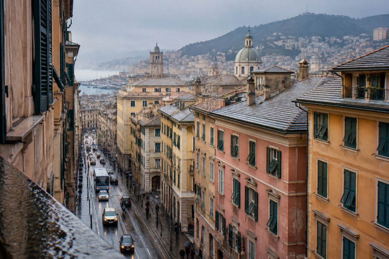 Taxis and buses moving along a Genoa street with tall painted buildings on both sides