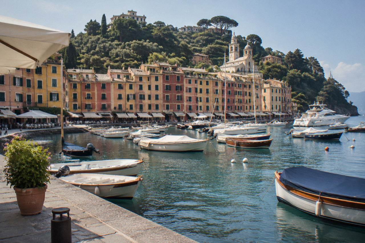 Colourful buildings around the small harbour of Portofino with boats moored in the water