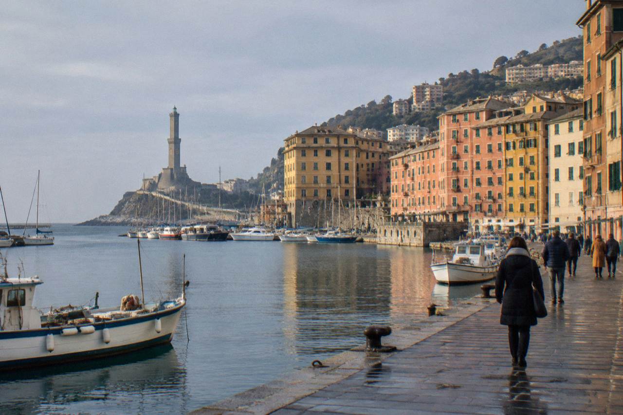 The old harbour of Genoa on a calm winter day with the Lanterna lighthouse in the distance