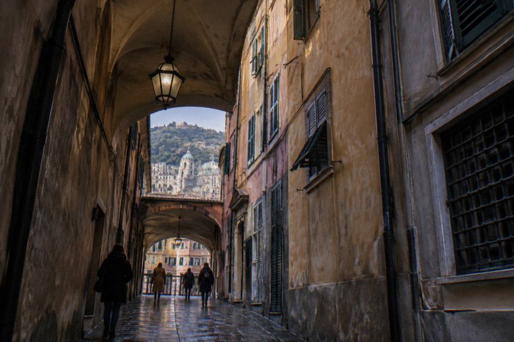 A narrow covered lane in the medieval old town of Genoa in winter light