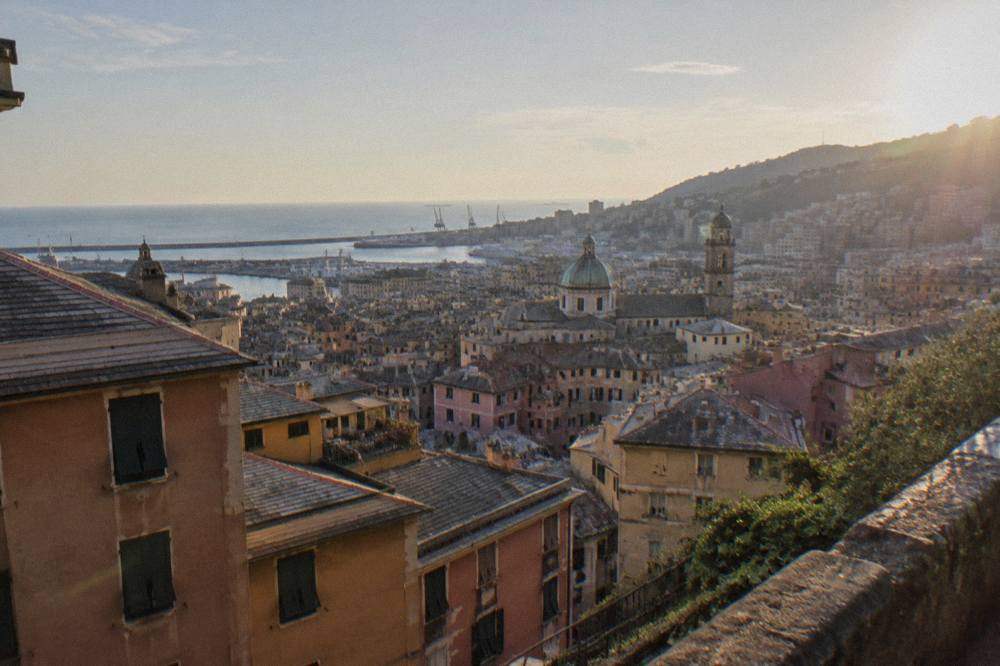 A view over the rooftops of Genoa towards the Ligurian Sea from a hillside terrace