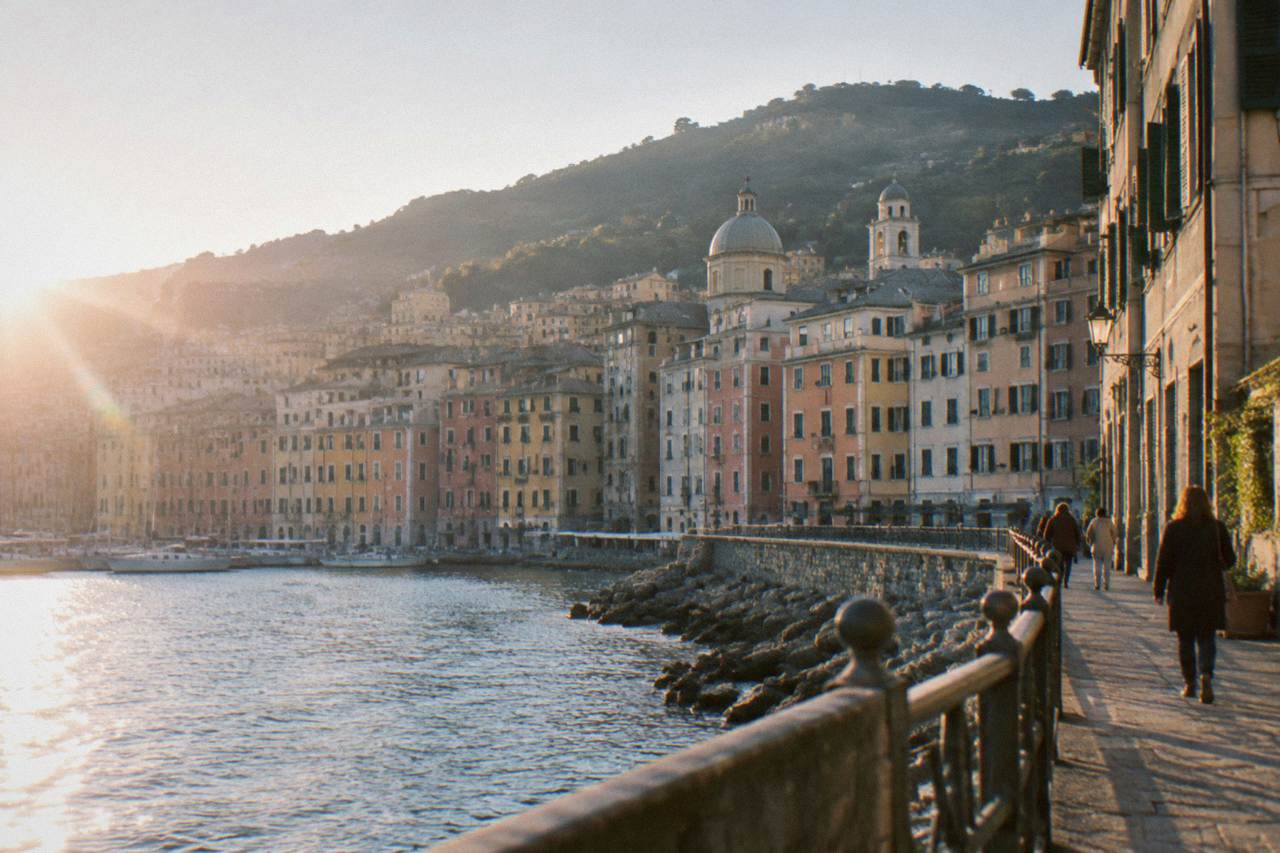 Apartment buildings of a residential Genoa neighbourhood rising behind a seaside promenade