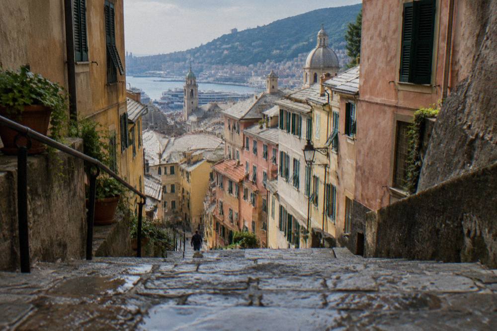 Steep stone staircase street in the old town of Genoa climbing between old buildings