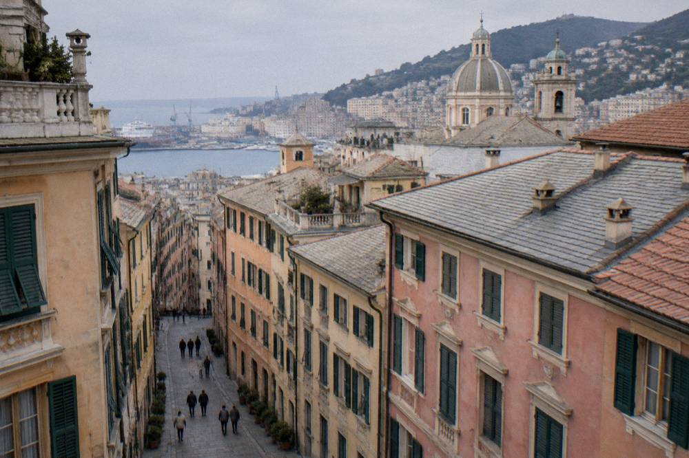 Renaissance street in Genoa lined with large restored palaces and painted facades