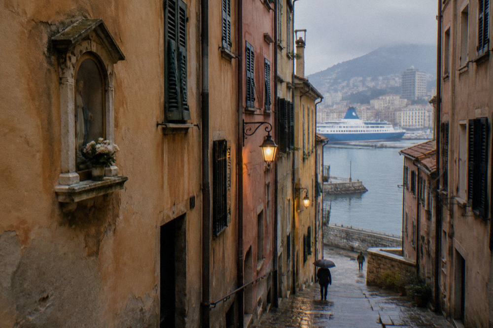 Blue and white ferry and harbour water seen from a stone quay in Genoa