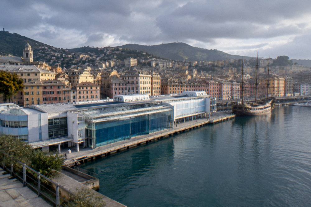 Rain clouds over the old harbour of Genoa with the Aquarium building below