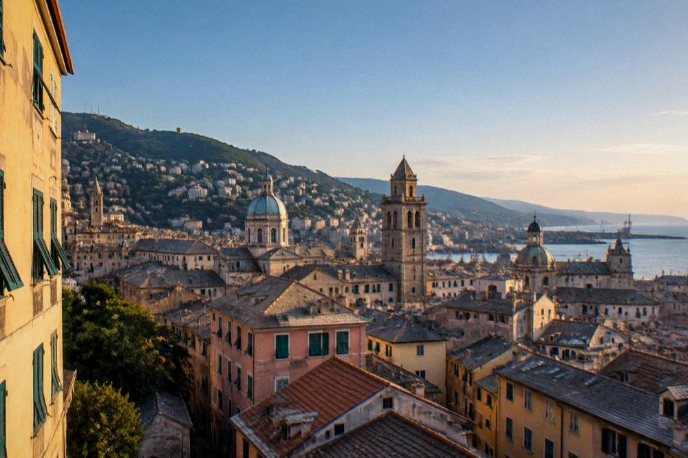 Evening light on old stone towers and rooftops in Genoa's historic centre