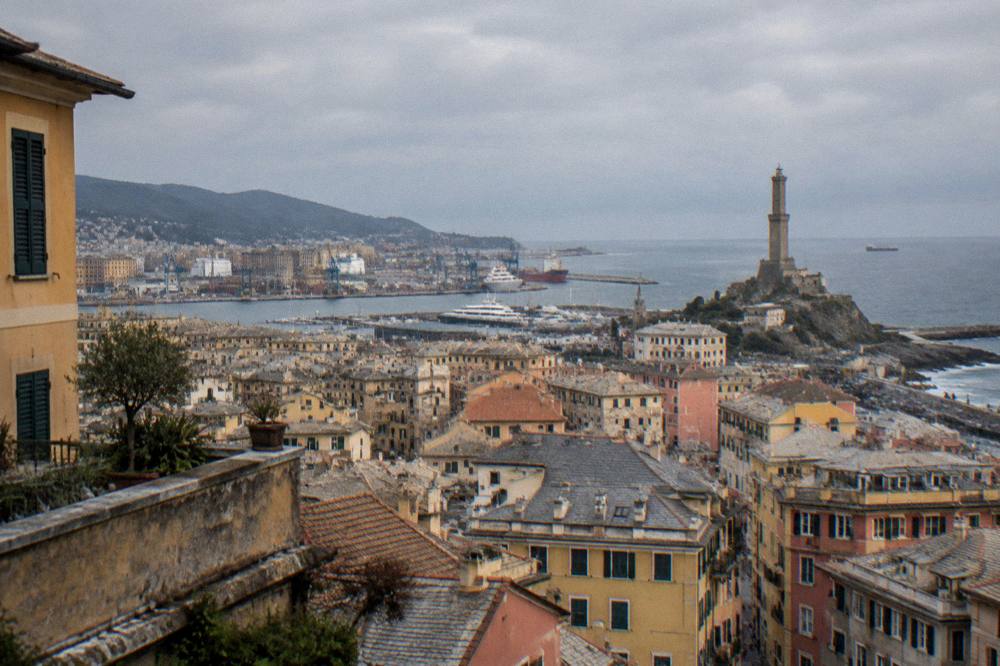 Panorama of Genoa's rooftops and harbour seen from a high terrace