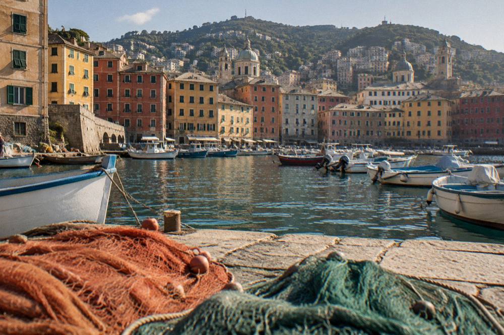 Fishing boats and coloured houses on the Ligurian coast near Genoa at golden hour