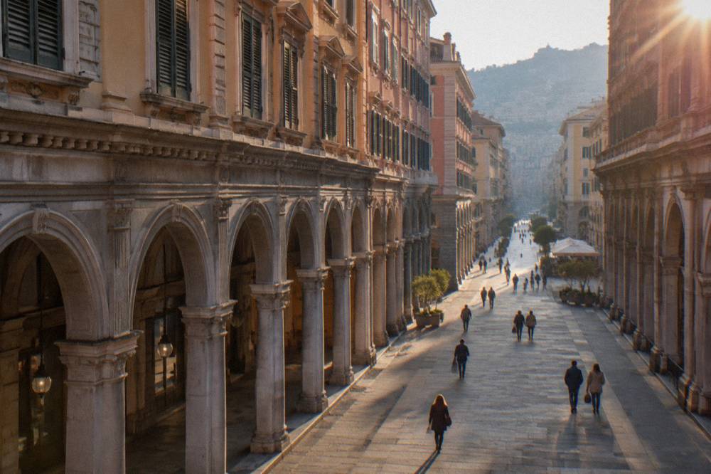 Shoppers walking along Via XX Settembre with its arcades and porticoes in Genoa