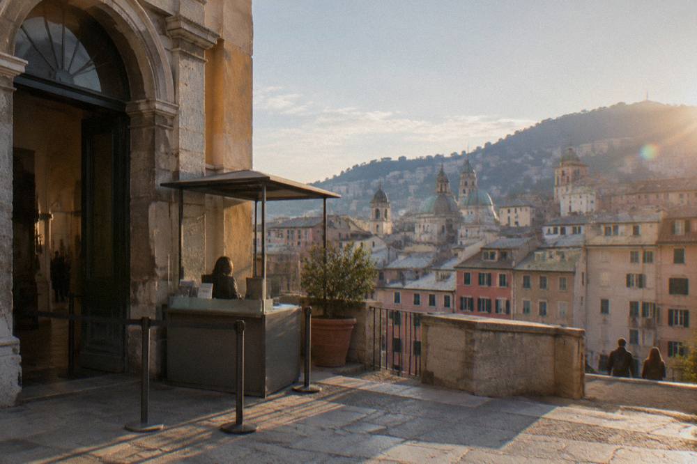 A ticket desk and stone doorway of a civic museum in Genoa