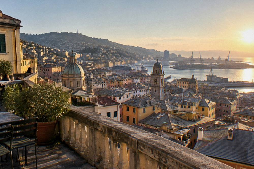 A panoramic terrace overlooking the rooftops and harbour of Genoa at golden hour
