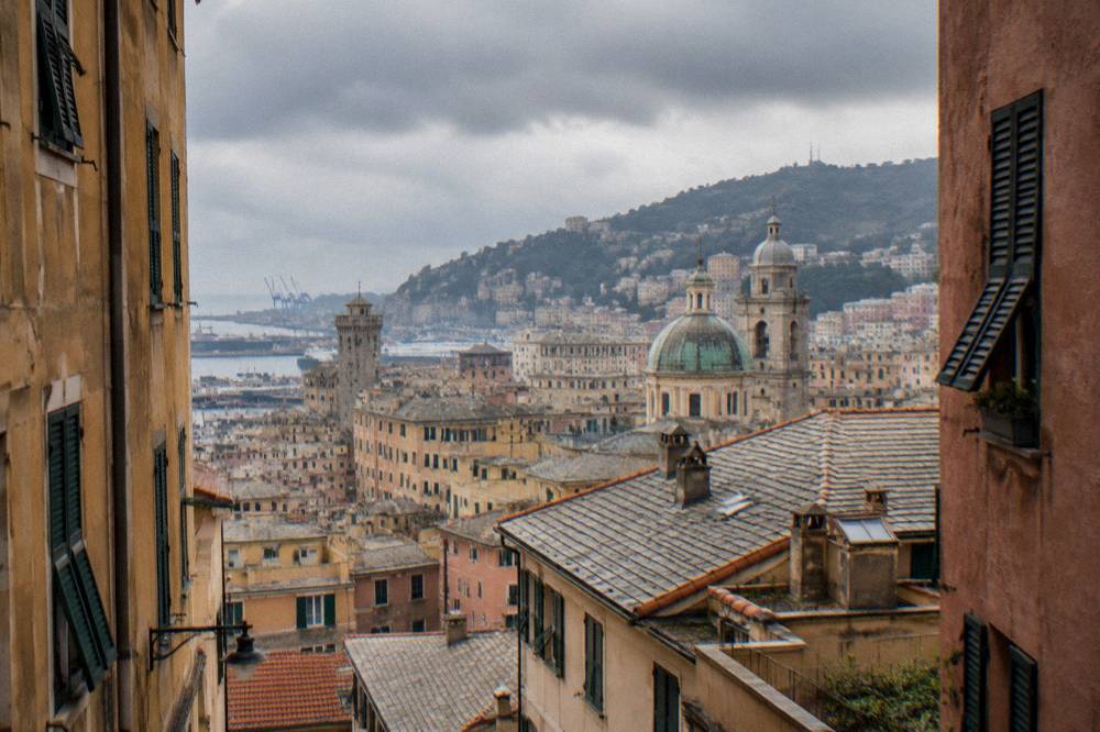 Rain clouds over the rooftops and towers of central Genoa