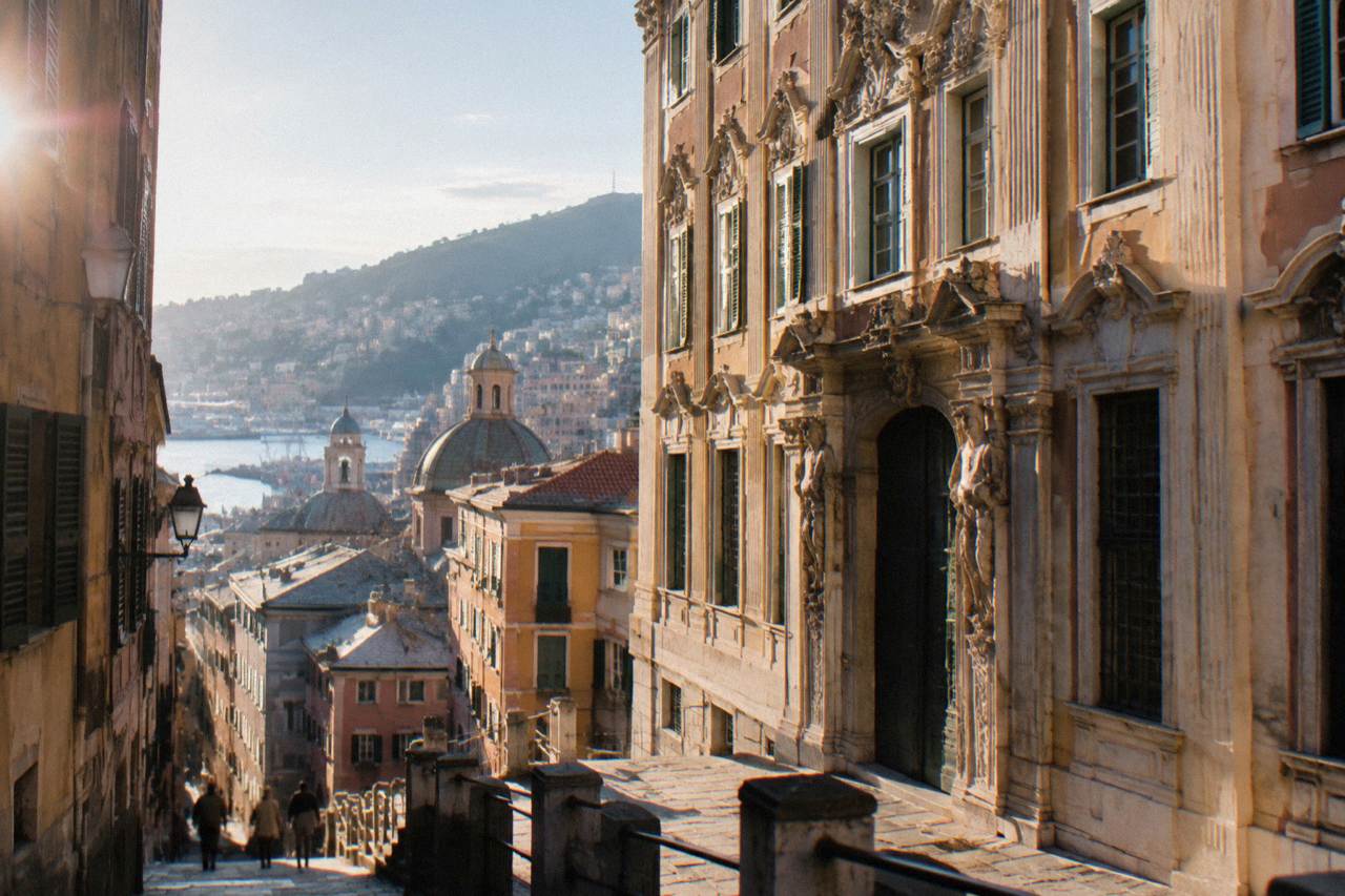 Ornate baroque facade of a grand palace on a Genoa street with tall windows