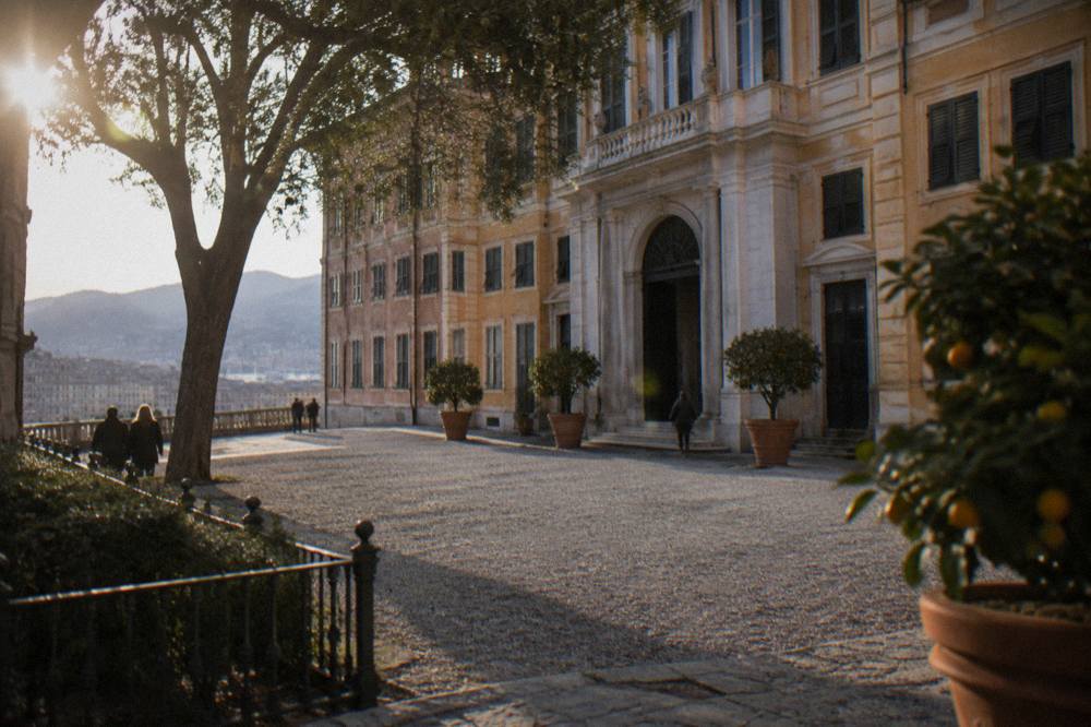 Stone palace courtyard with arcades and potted orange trees