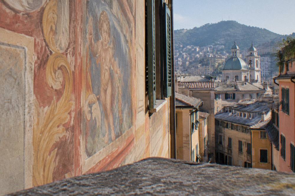 Close view of painted fresco decoration on a palace wall in Genoa