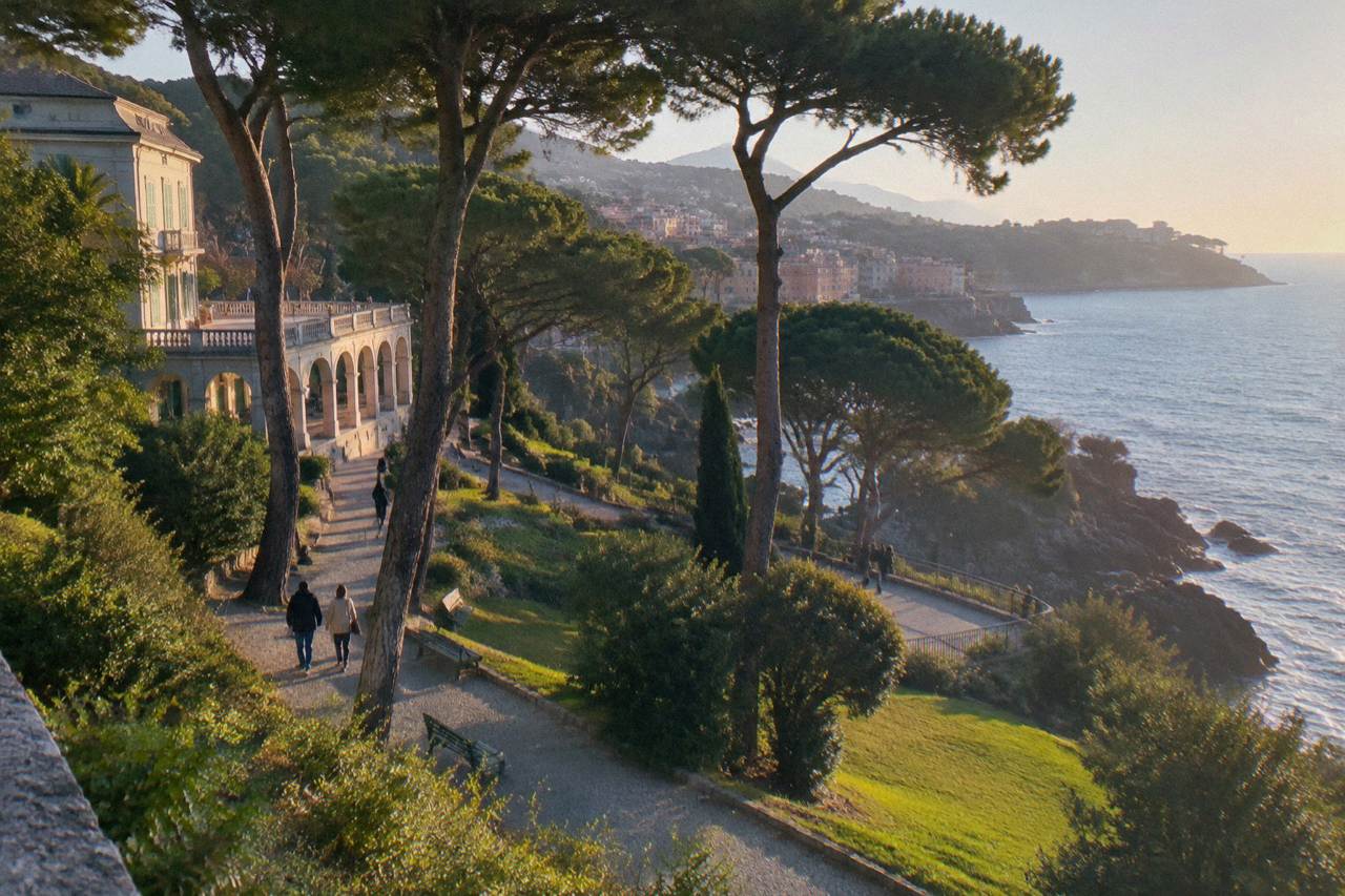 Cliff-top seaside promenade with pine trees above a rocky shoreline on the Ligurian Sea