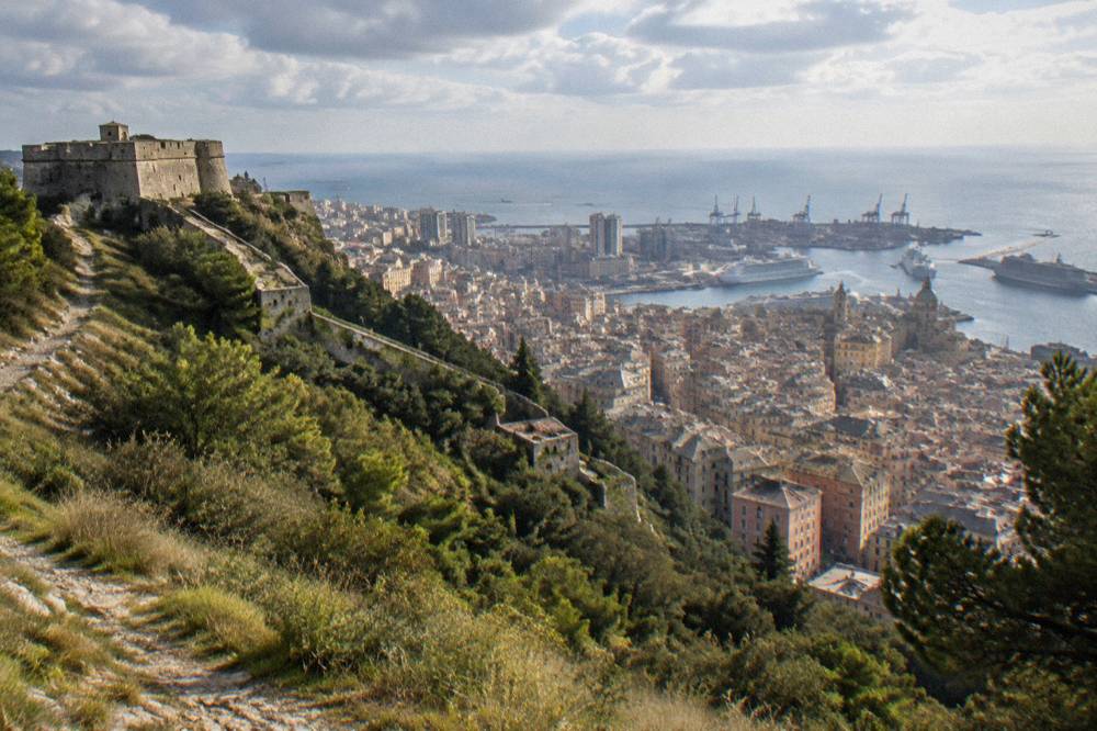 Panoramic view over Genoa's rooftops, port and sea from a hilltop fort