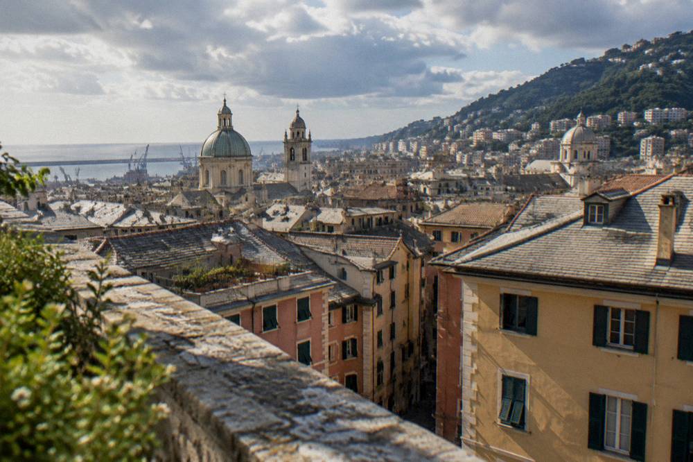 Rooftops of central Genoa seen from a high stone terrace near the city walls
