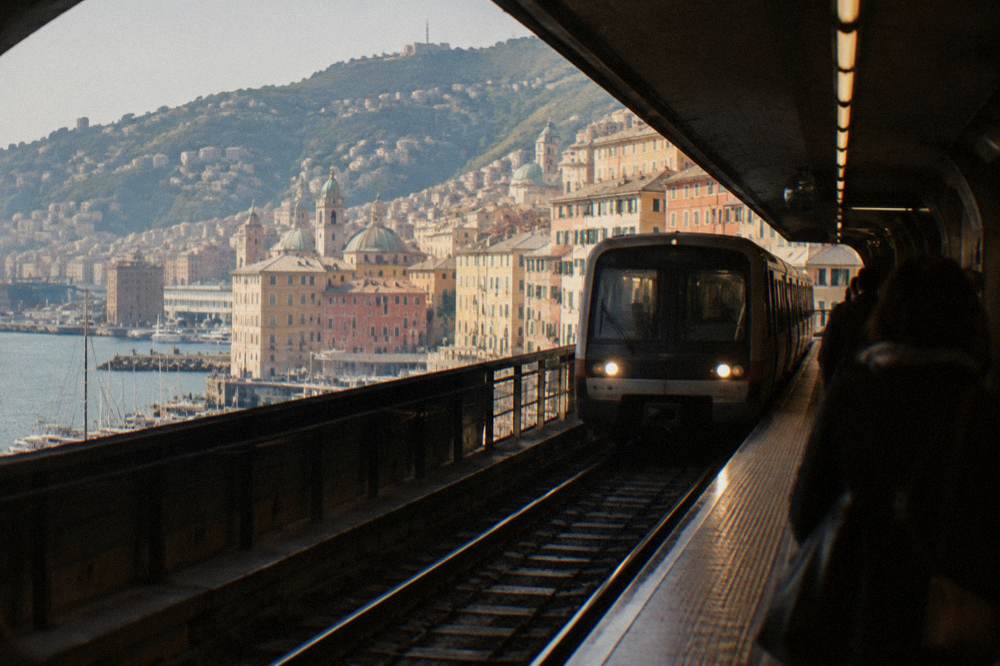 A metro train arriving at an underground station in Genoa near the waterfront