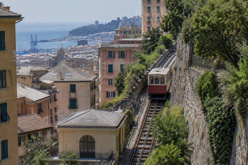 A hillside funicular carriage on an inclined track above city rooftops