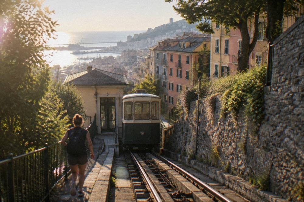 A public lift and funicular station on a steep Genoa hillside with the city below