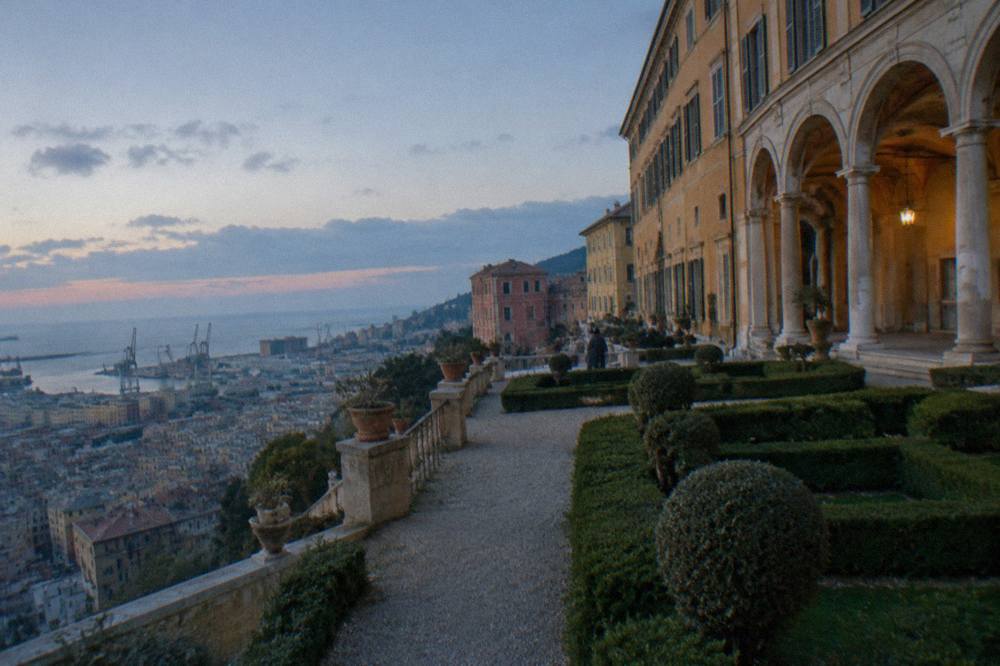 Stone loggia arches of an Italian Renaissance palace overlooking the sea