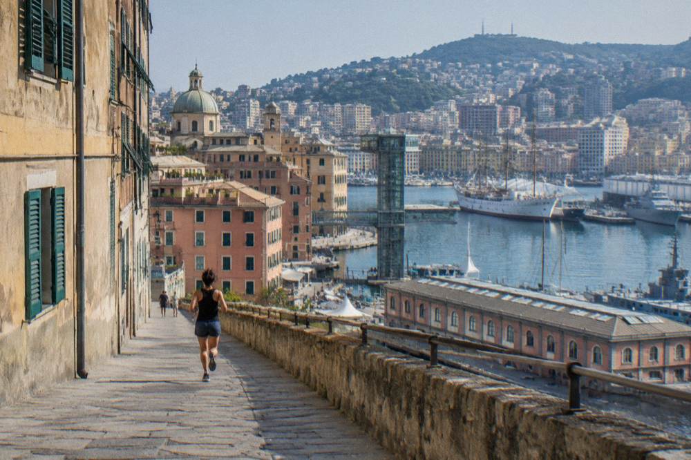 The old harbour of Genoa with a panoramic lift, museum ships and hills behind