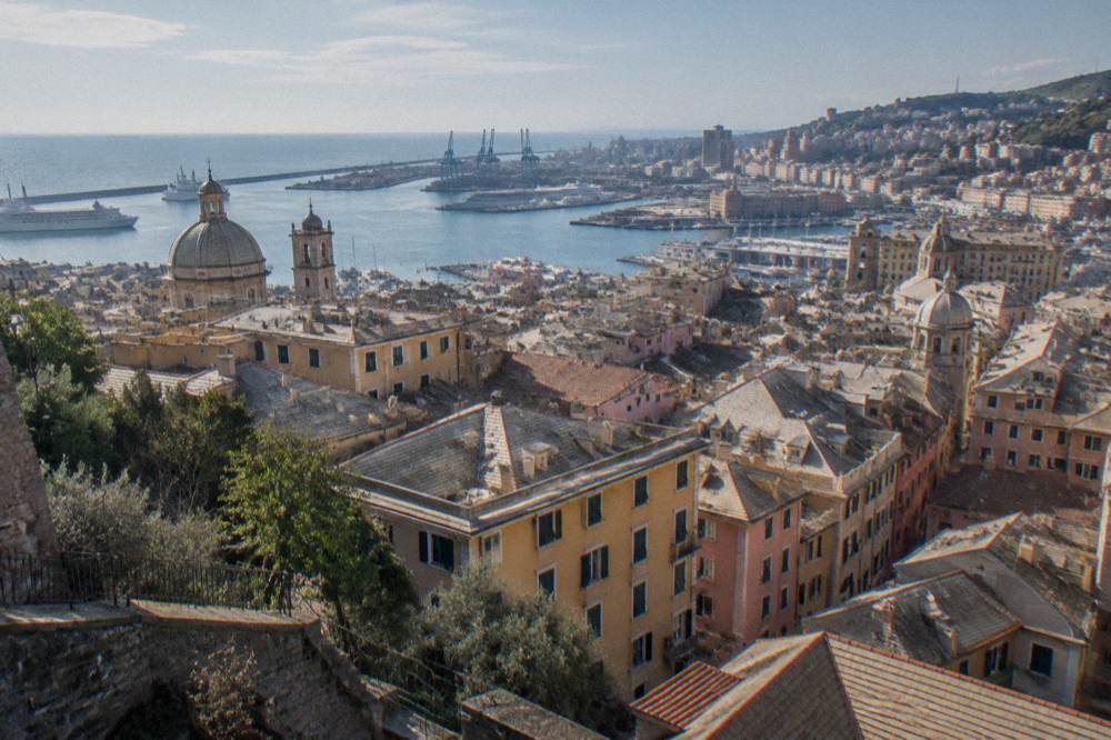 Panoramic view over the rooftops, harbour and sea of Genoa from a hilltop