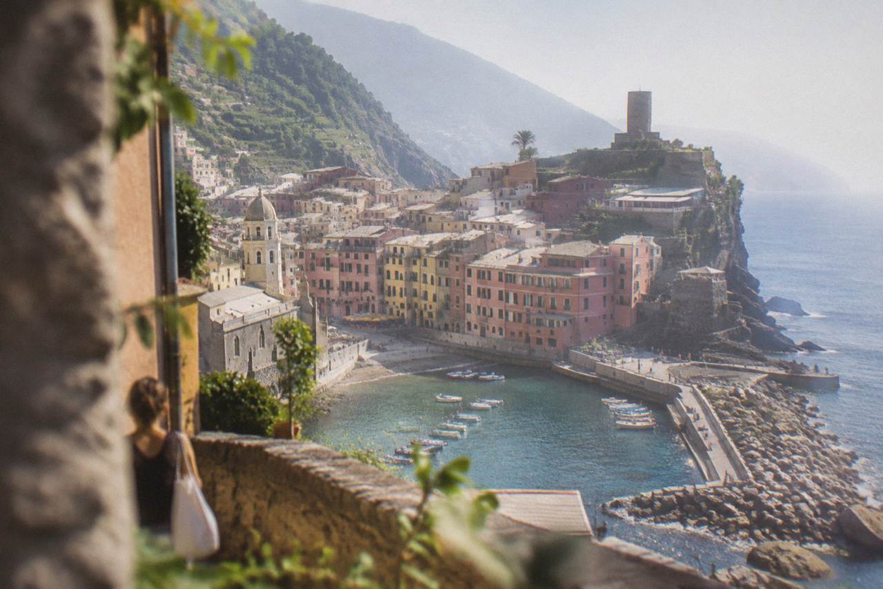 Colourful houses stacked above a small harbour on the Ligurian coast