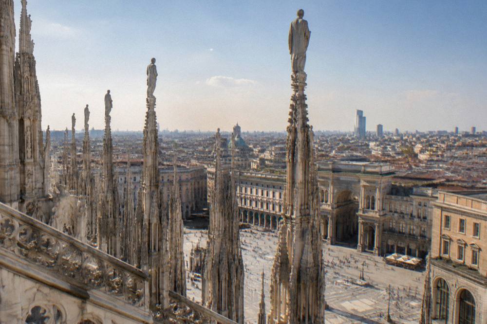 The spires of Milan Cathedral seen from a rooftop terrace