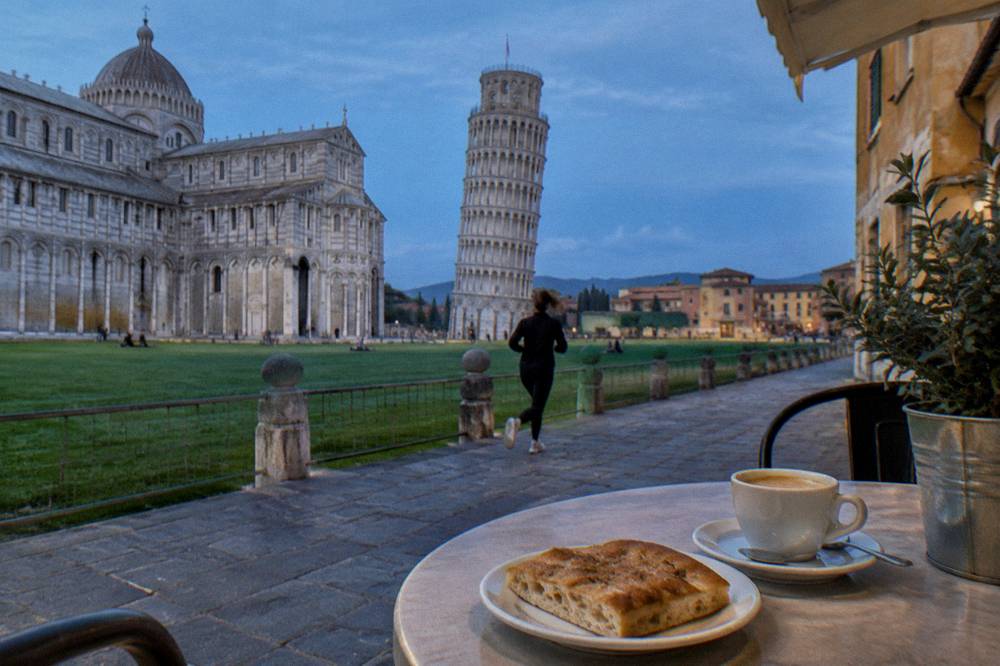 A coffee and a slice of focaccia on a cafe table in Genoa