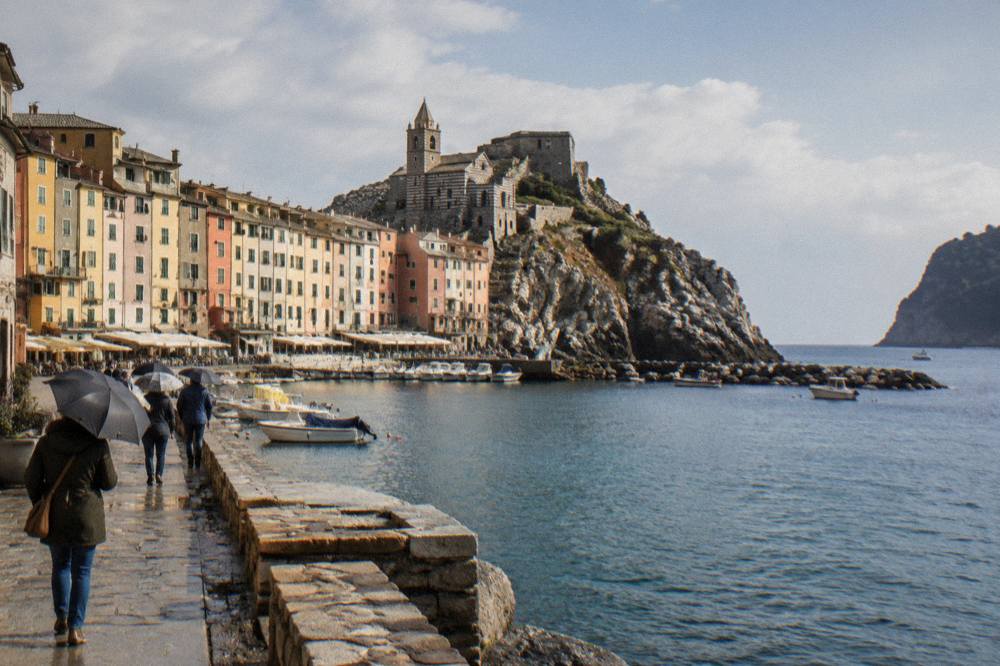A rocky island coastline with Mediterranean scrub falling steeply into clear sea