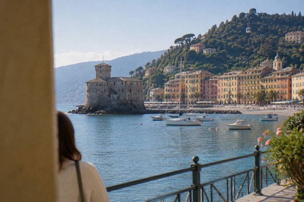 A cable car cabin ascending the wooded hillside above Rapallo