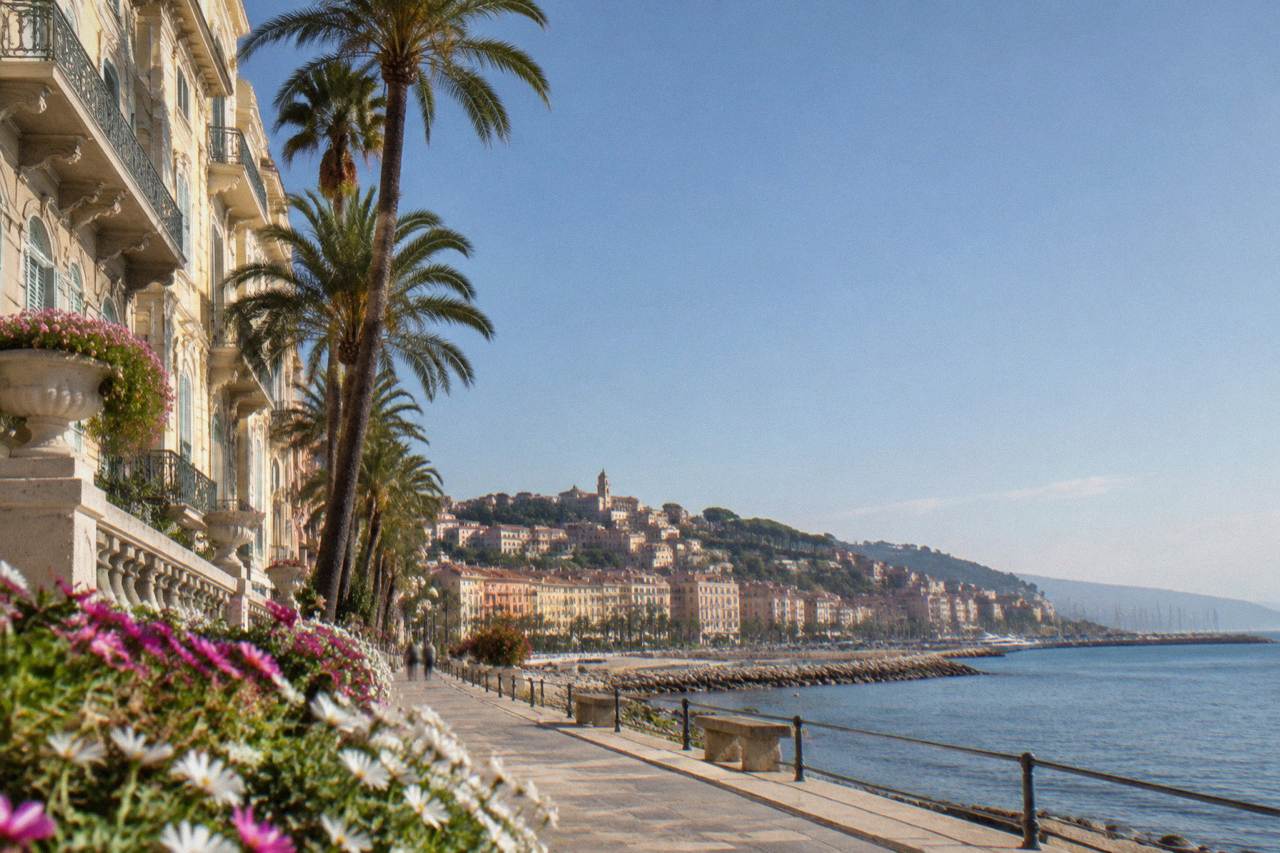 Pastel buildings along the Sanremo seafront with the promenade and the Ligurian Sea beyond