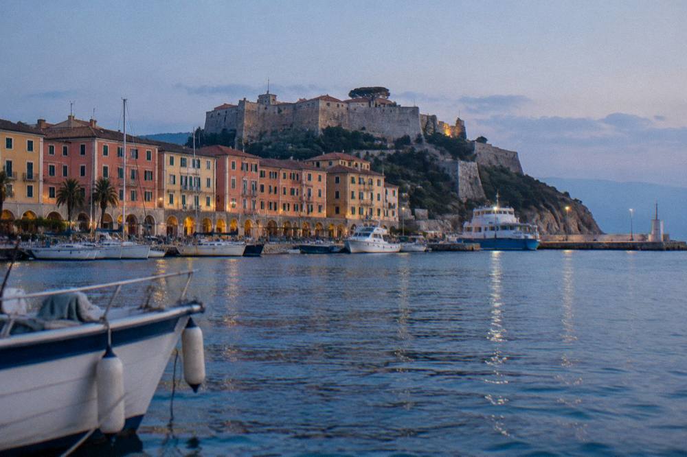 A small Ligurian coastal town seen from the water with coloured facades