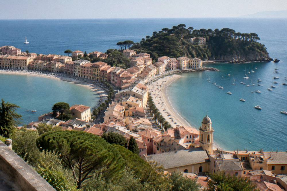 Aerial view of a Ligurian peninsula town surrounded by turquoise sea on two sides