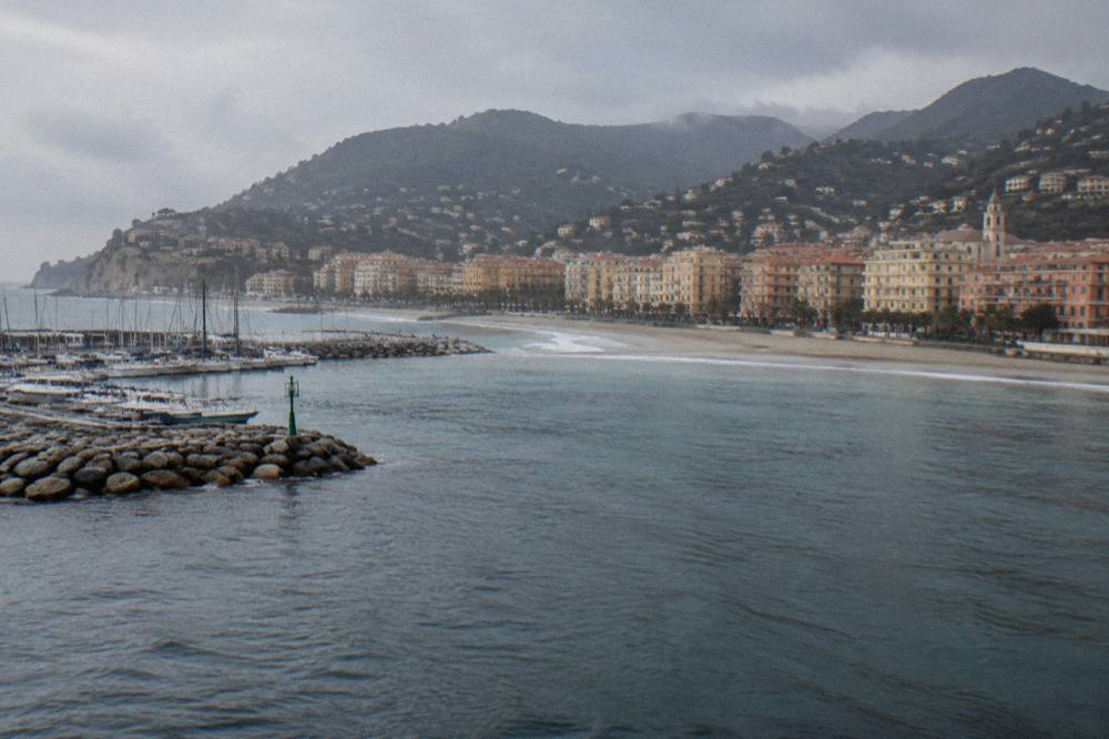 A small Ligurian coastal town seen from the water with hills behind