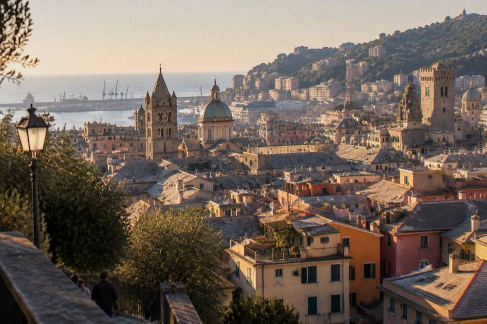 Sunlit rooftops and towers of Genoa seen from the Spianata Castelletto viewpoint