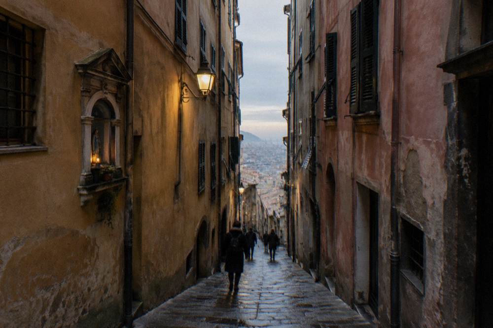The narrow caruggi lanes of the Genoa old town lit by winter afternoon light
