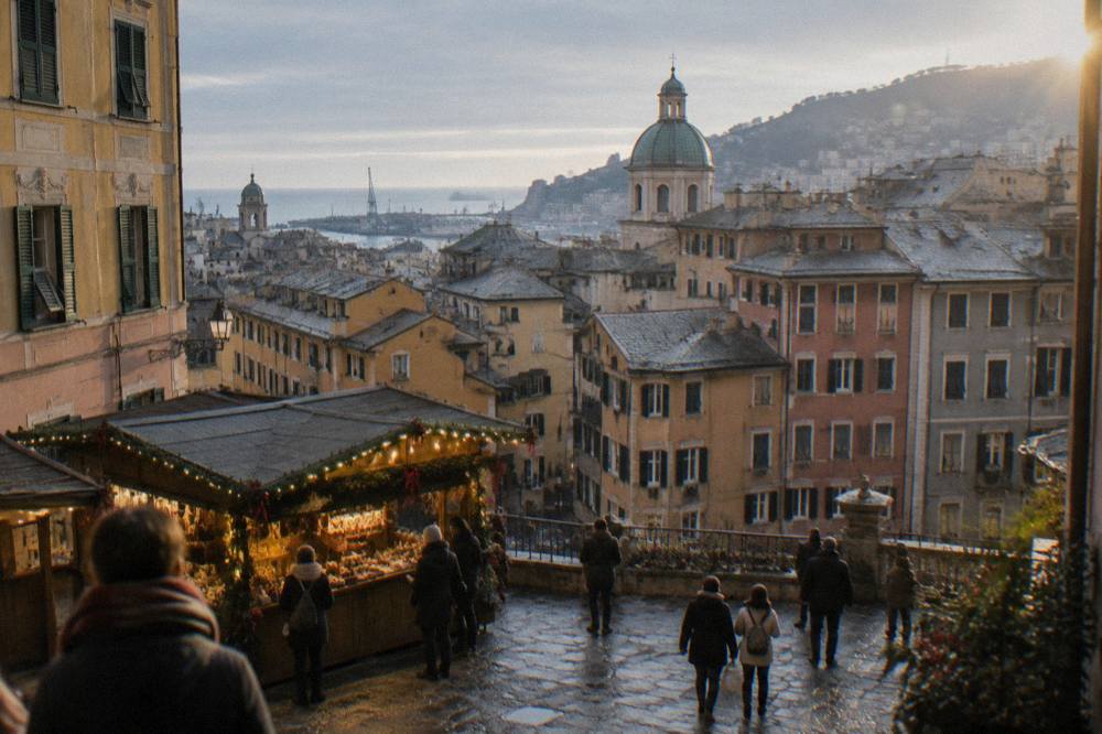 A wooden market stall with holiday decorations in a lit square in Genoa