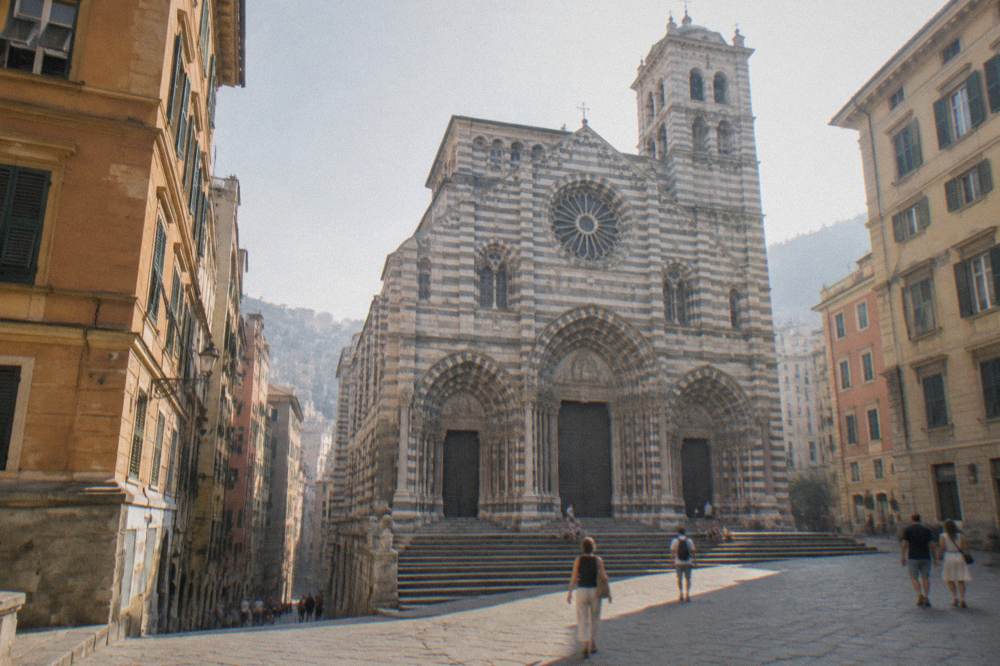 The striped Cathedral of San Lorenzo seen from a square in central Genoa