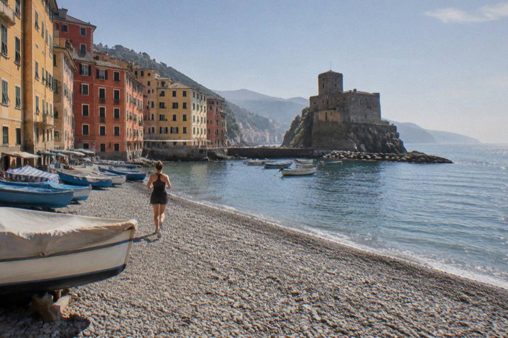 Colourful waterfront houses above a small harbour with fishing boats in Camogli