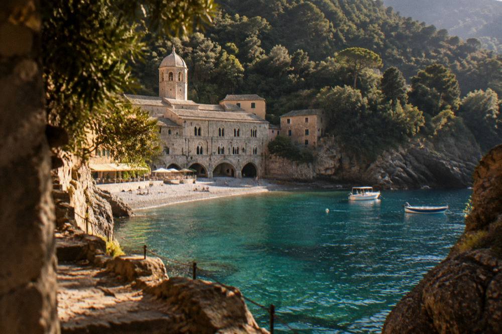 A stone abbey on a small pebble beach reachable only by boat at San Fruttuoso