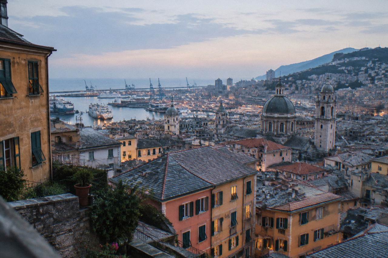 View over the rooftops and harbour of Genoa with the sea in the distance