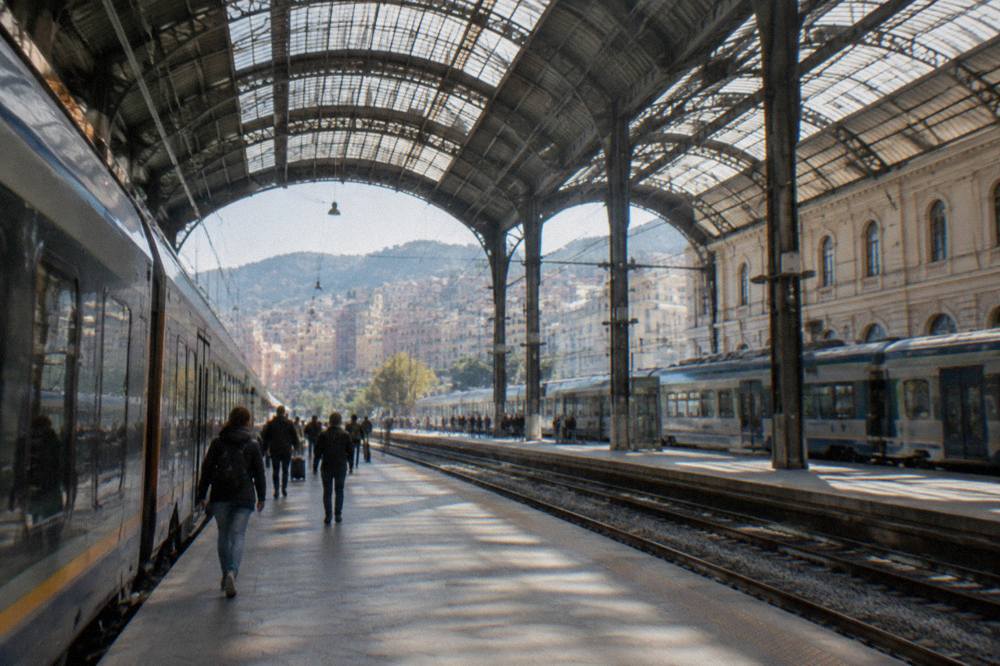 Railway platforms under the glass roof of a large Italian train station