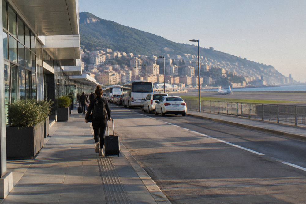 The departures forecourt of a small Italian airport with taxis and buses waiting