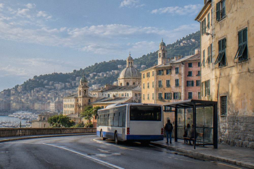 A bus stopping at a shelter on a Genoa street beside old buildings
