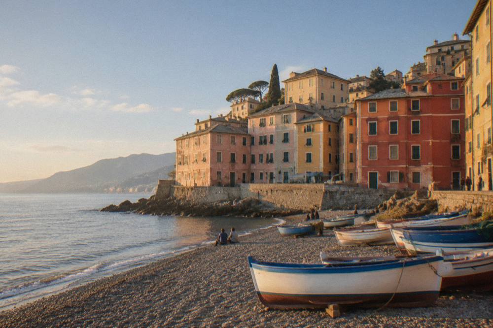 Pebble beach and colourful apartment buildings at Boccadasse on a bright morning